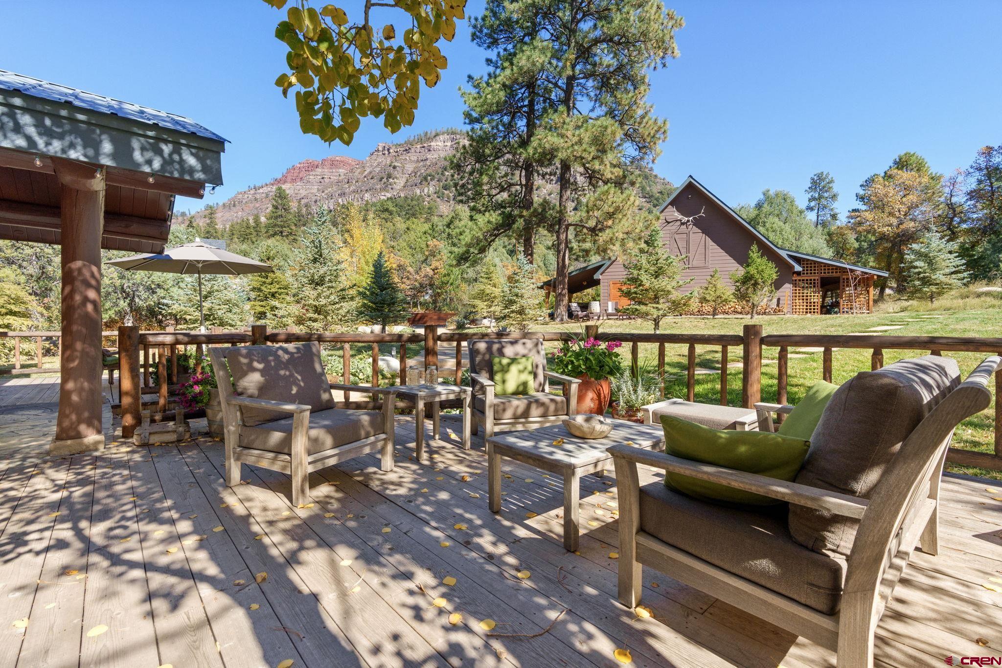 114 Rimrock Drive Durango, CO 81301 - Photo 30 of 42 a view of a patio with couches table and chairs and potted plants