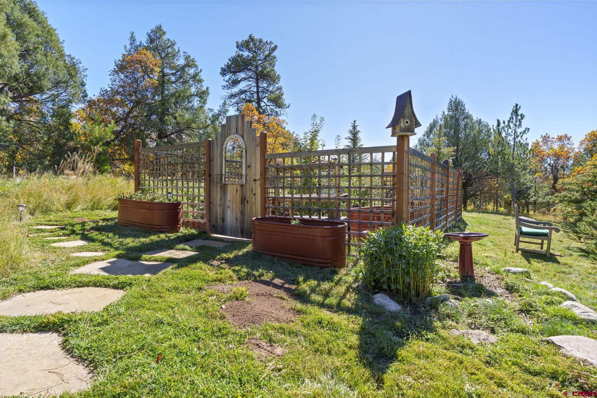 114 Rimrock Drive Durango, CO 81301 - Photo 33 of 42 a view of a garden with a bench in a garden