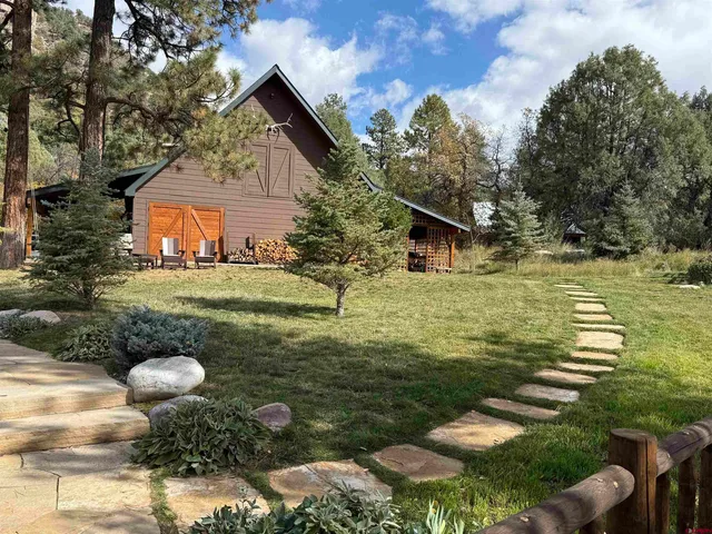 a front view of a house with a yard swimming pool and outdoor seating