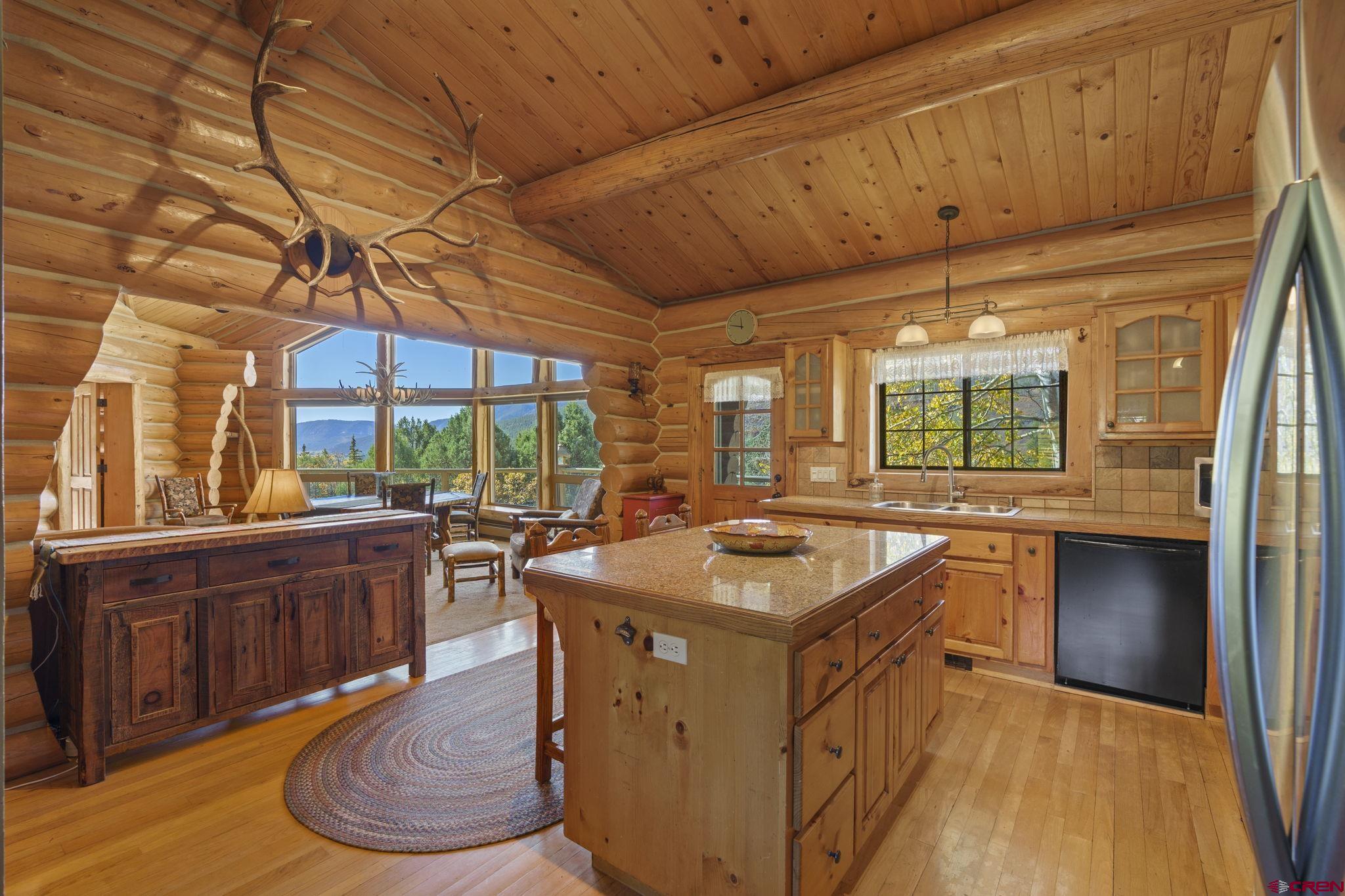 114 Rimrock Drive Durango, CO 81301 - Photo 9 of 42 a kitchen with a sink stove and cabinets