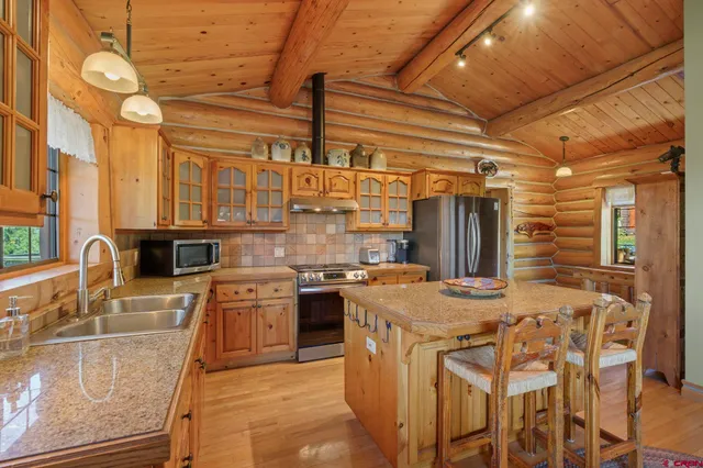 a kitchen with cabinets and chairs