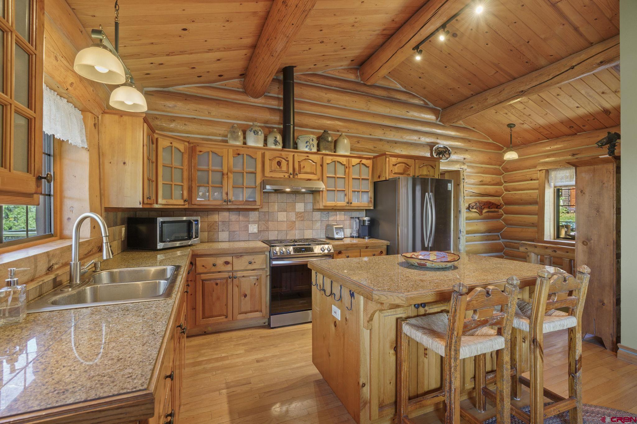 114 Rimrock Drive Durango, CO 81301 - Photo 10 of 42 a kitchen with cabinets and chairs