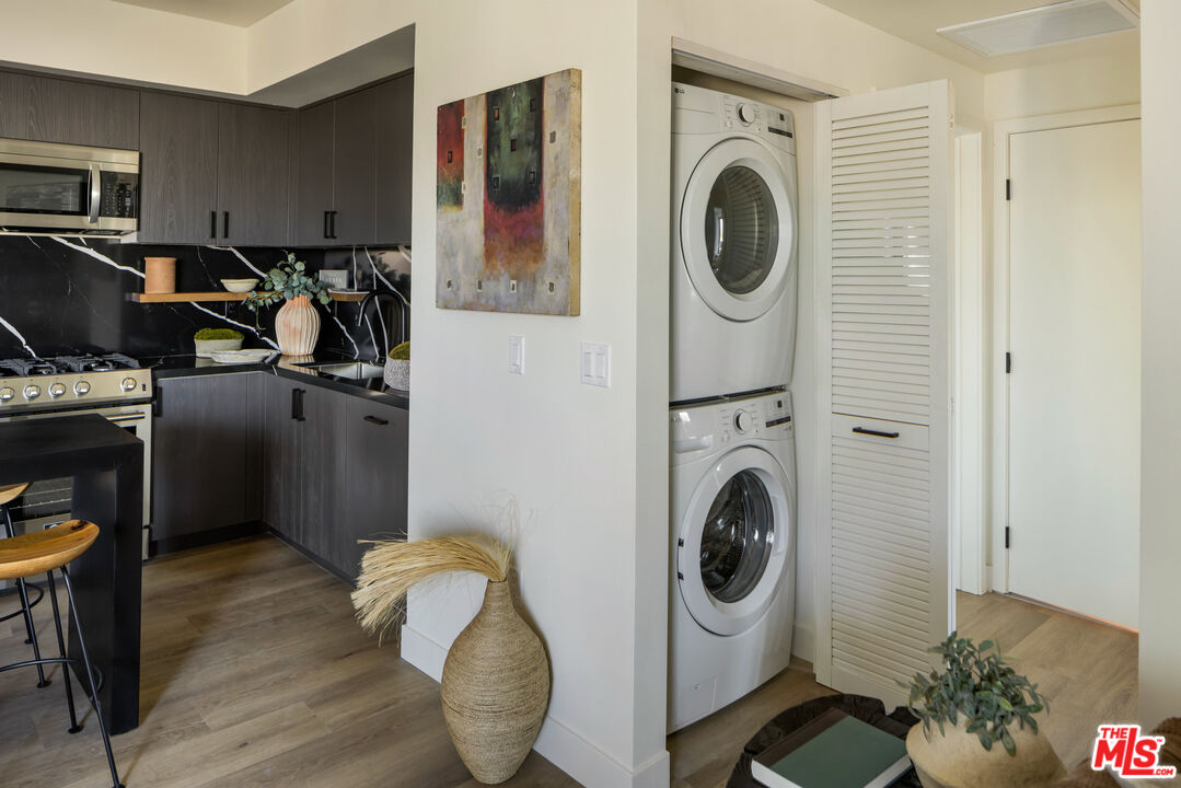 1110 South Spaulding Avenue, Unit 102 Los Angeles, CA 90019 - Photo 4 of 13 a view of a storage and utility room with washer and dryer