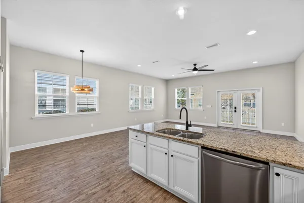 a kitchen with granite countertop a sink and a window