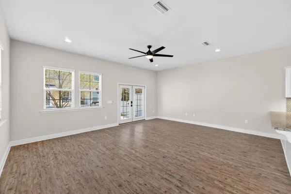 wooden floor in an empty room with a window