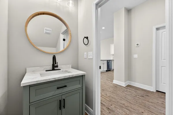 a view of bathroom with a sink and mirror