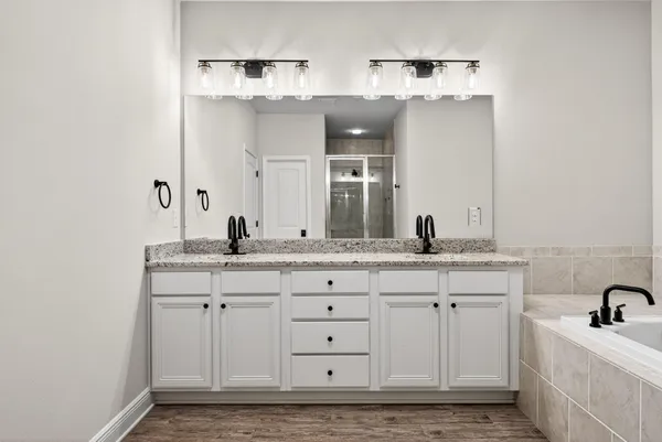 a bathroom with double sink and a mirror