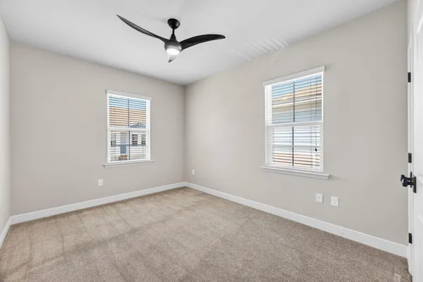 an empty room with windows and closet
