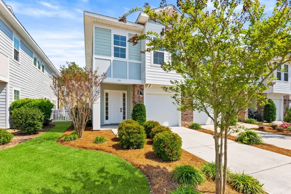 a front view of a house with a yard and garage