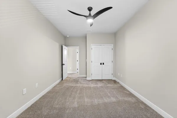 wooden floor in a hall with a ceiling fan