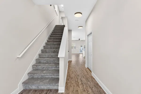 a view of entryway and hall with wooden floor