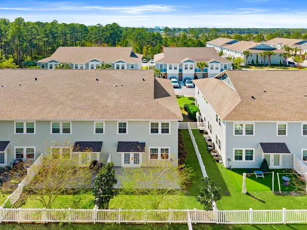 an aerial view of multiple houses with a swimming pool