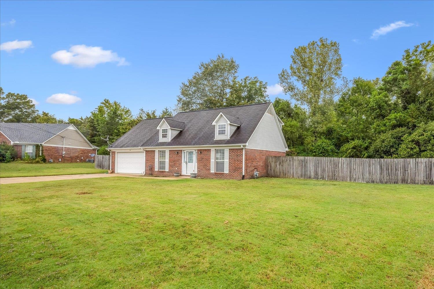 46 Countryside Circle Brighton, TN 38011 - Photo 20 of 23 a view of a big house with a big yard and a large tree