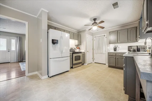 a kitchen with stainless steel appliances a stove a sink and a refrigerator