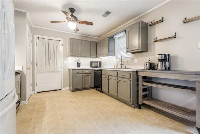 a kitchen with a sink stove and cabinets