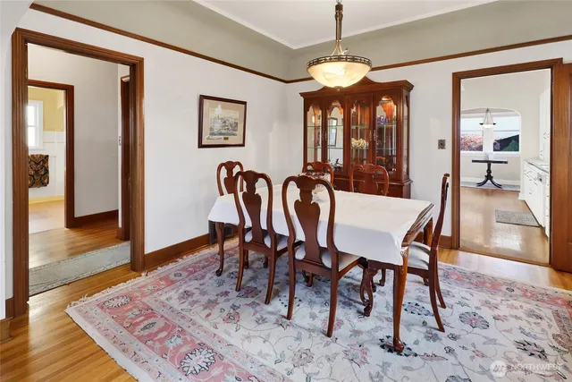 a view of a a dining room with furniture window and wooden floor