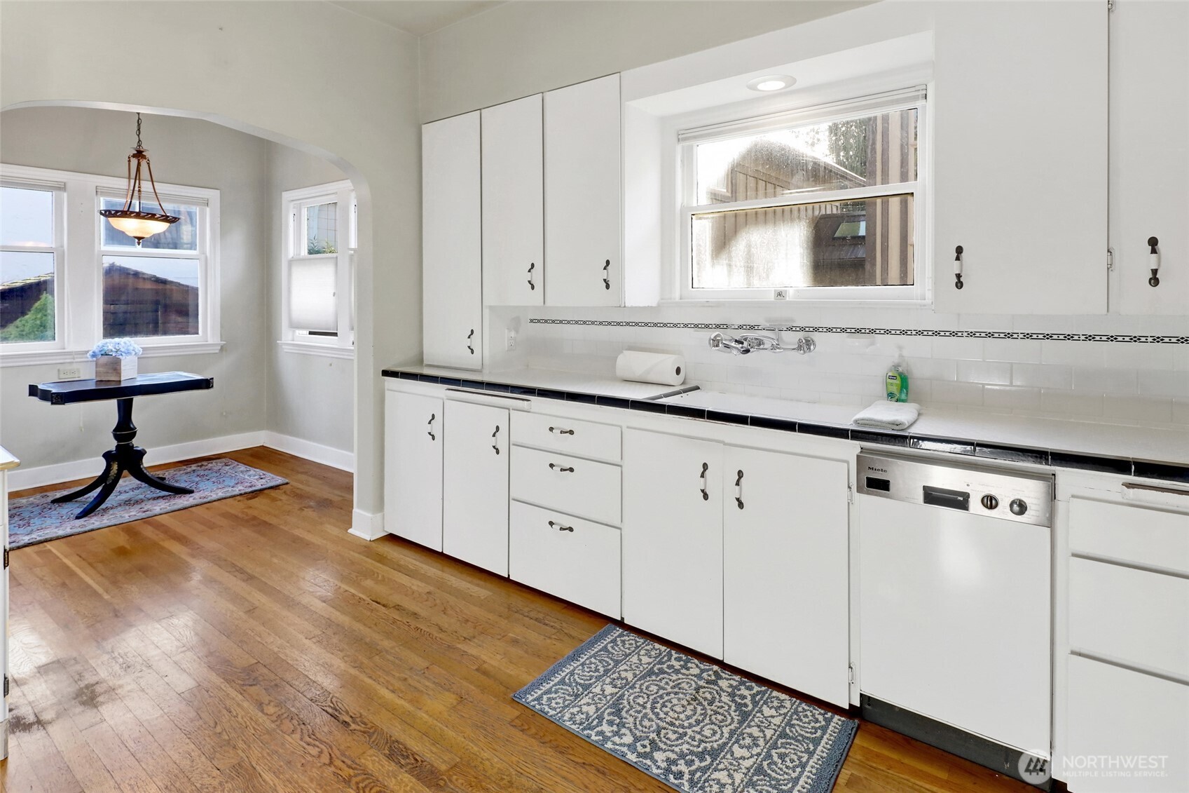 1211 14th Street Bellingham, WA 98225 - Photo 10 of 38 a kitchen with granite countertop white cabinets and white appliances