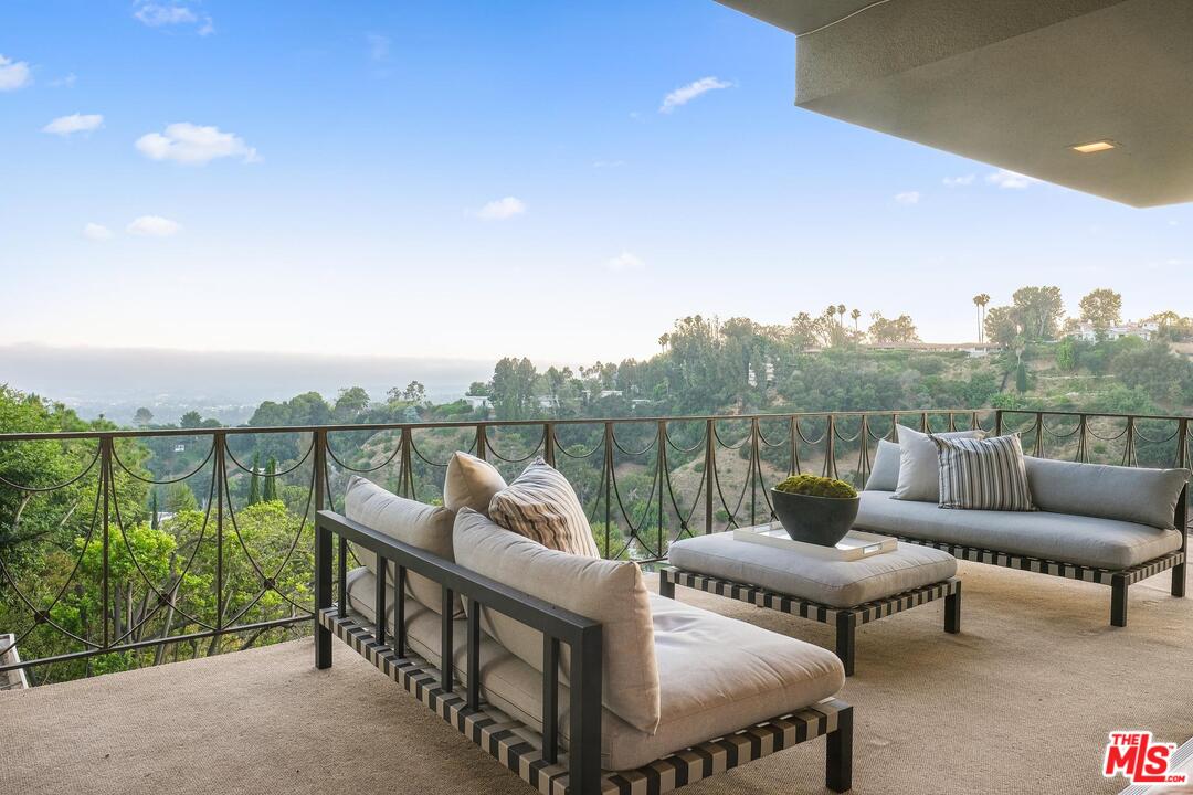 11284 Chalon Road Los Angeles, CA 90049 - Photo 1 of 14 a view of a terrace with couches and a potted plant