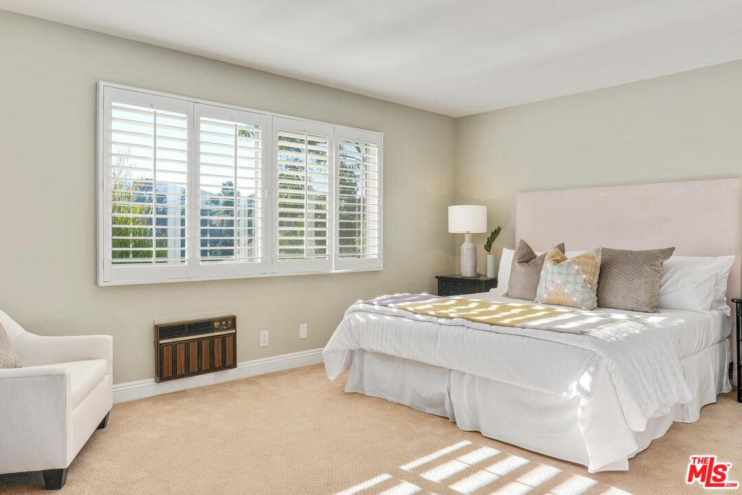 11284 Chalon Road Los Angeles, CA 90049 - Photo 11 of 14 a bedroom with a bed and a couch