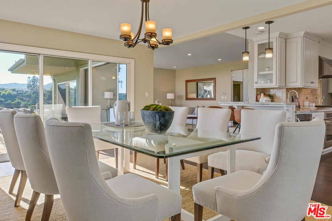 11284 Chalon Road Los Angeles, CA 90049 - Photo 6 of 14 a view of a dining room with furniture and a chandelier