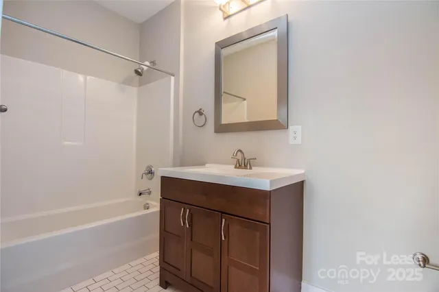 a bathroom with a sink toilet and mirror
