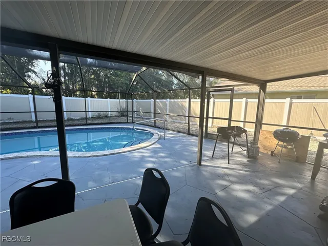 a dining room with furniture and floor to ceiling window