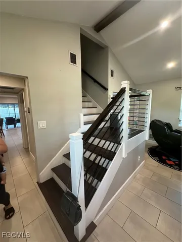 a living room with furniture and stairs