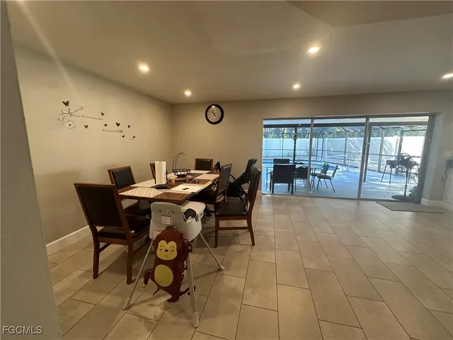 a view of a dining room with furniture a rug and wooden floor