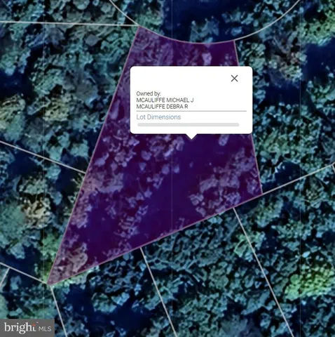 a sign that is sitting in front of flowers