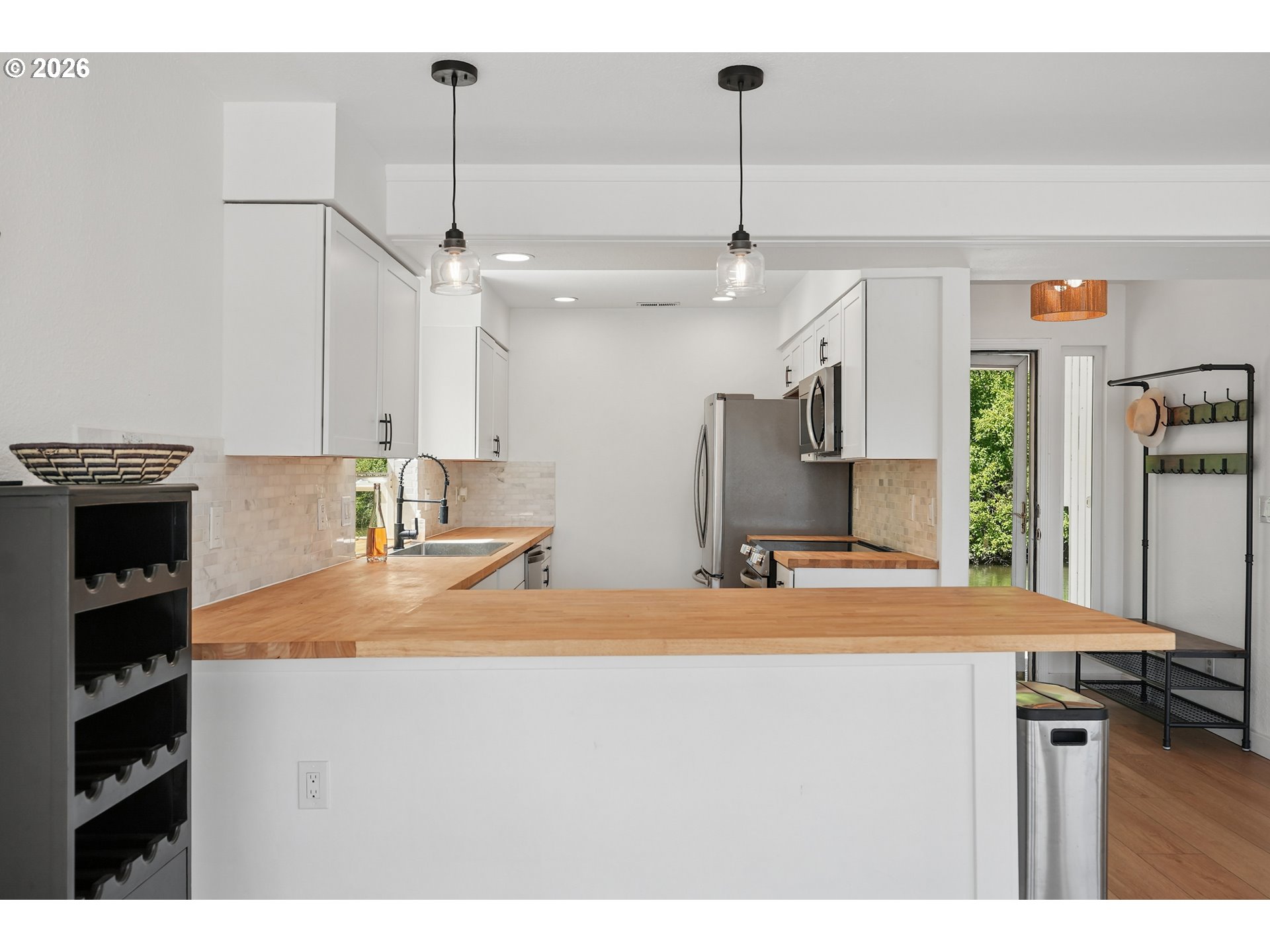 14936 Northwest Mill Road, Unit K Portland, OR 97231 - Photo 11 of 33 a kitchen with stainless steel appliances granite countertop a sink a stove and a refrigerator