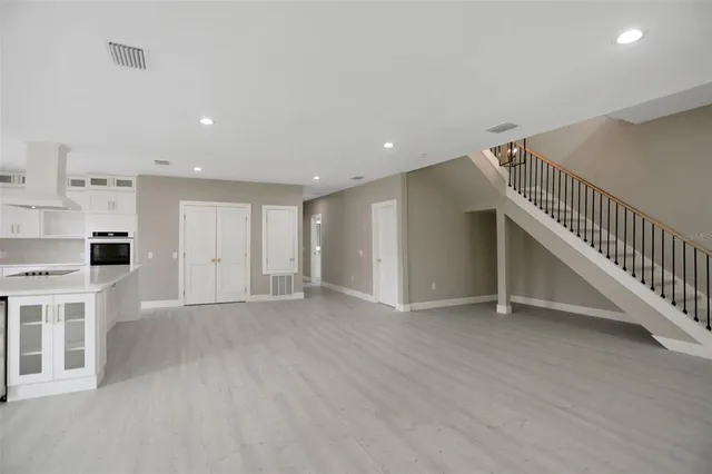 a bathroom with a tub a sink a mirror and a shower