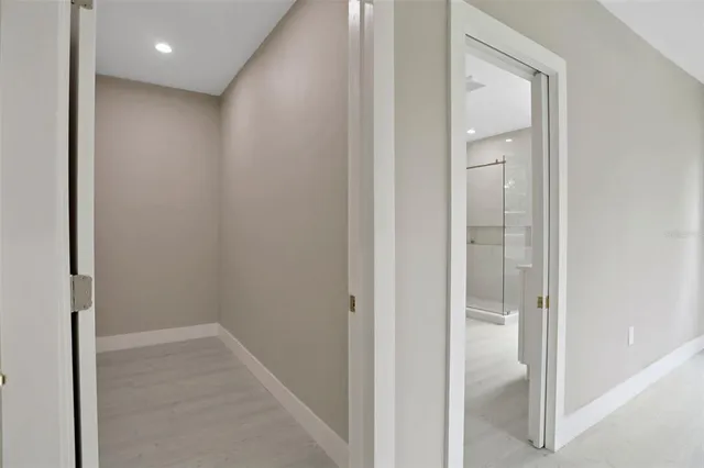 a big room with closet and a window