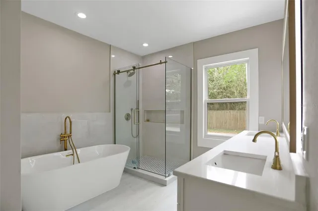 a bathroom with a shower sink vanity mirror and toilet