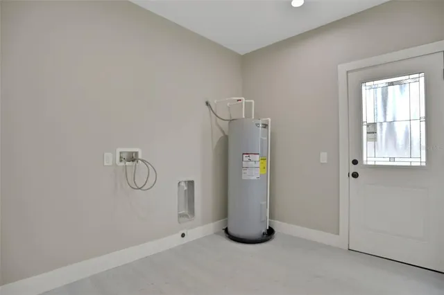 an empty room with a window and a ceiling fan