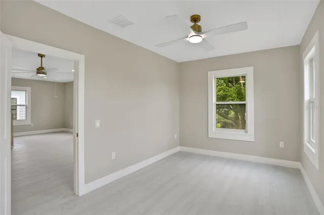 a grey house with yard in front of it