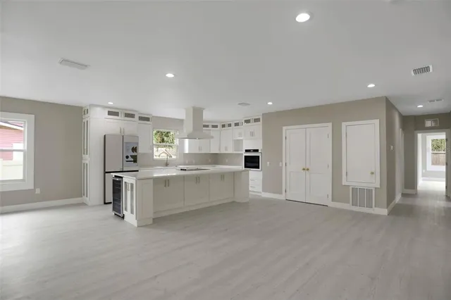 a kitchen with a refrigerator a sink and cabinets