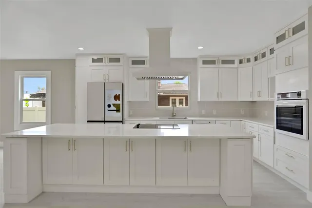 an empty room with windows and chandelier