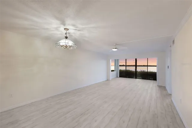 a view of a livingroom with wooden floor and a sink
