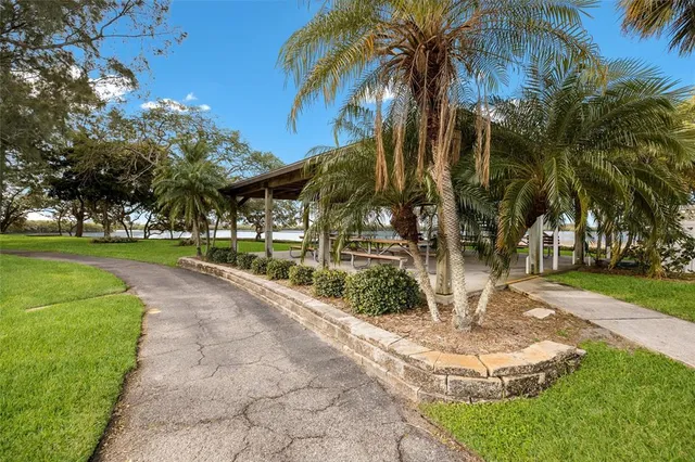 a view of a house with a big yard and large trees
