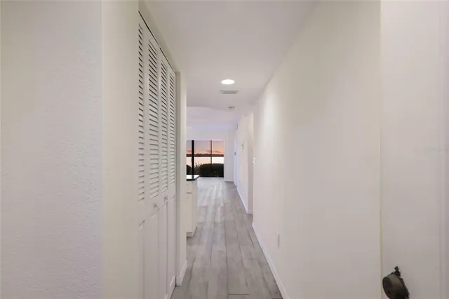 a kitchen with granite countertop white cabinets sink and stainless steel appliances