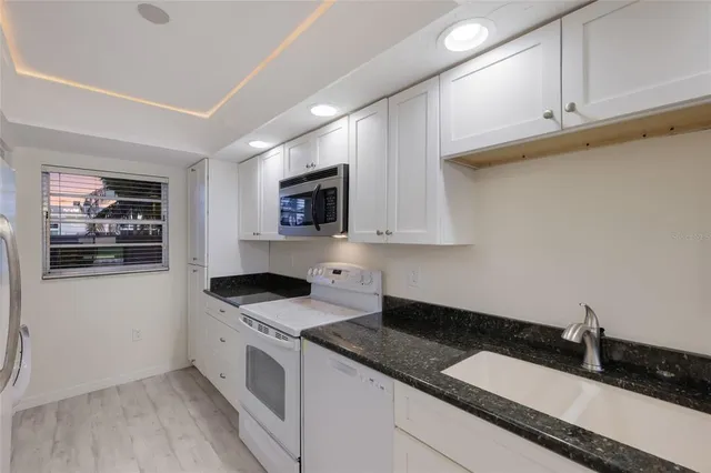 a kitchen with a sink stove and microwave