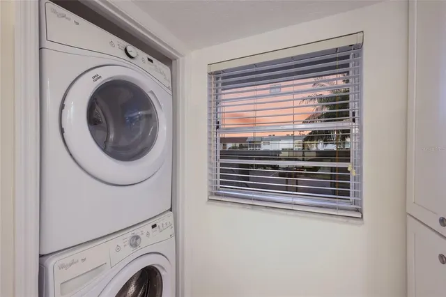 a view of a kitchen with granite countertop a sink and a stove