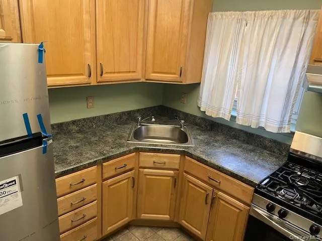 a kitchen with granite countertop a sink and cabinets