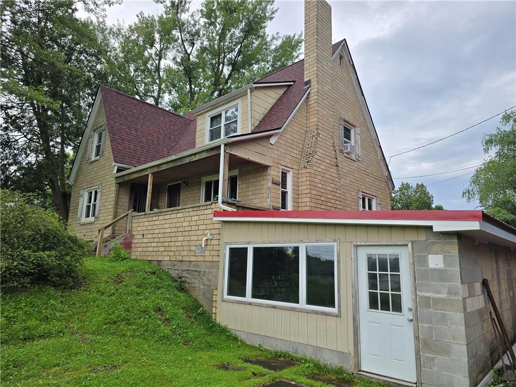 368 Pittsburgh Road Butler, PA 16002 - Photo 3 of 26 a view of a white house with large windows and a small yard