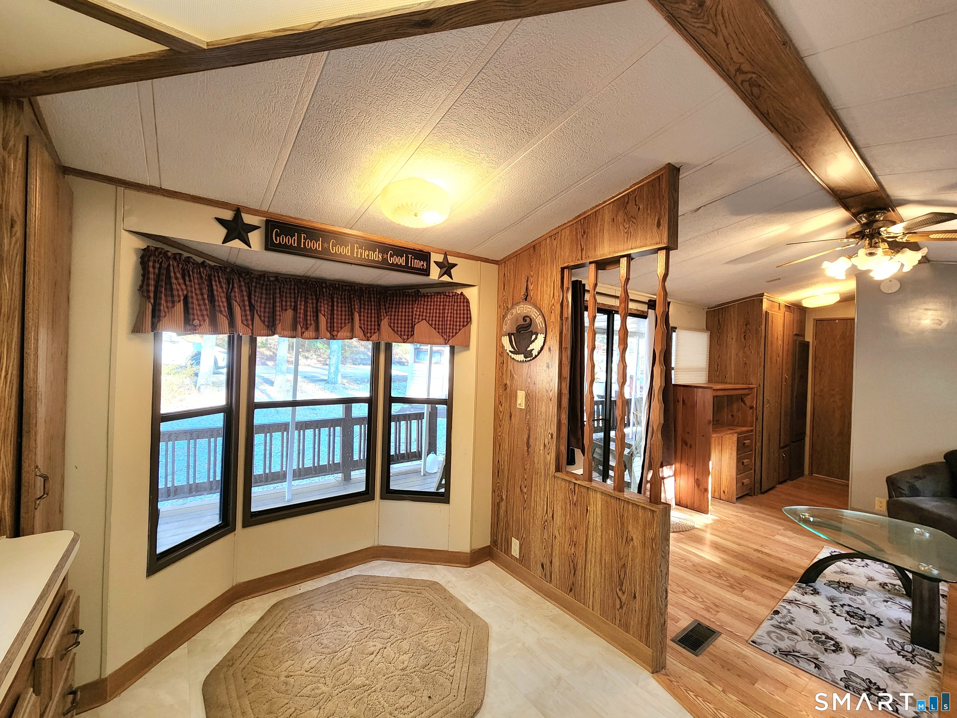 51 Old Springfield Road, Unit 123 Stafford, CT 06076 - Photo 15 of 19 a view of a bedroom with wooden floor and windows