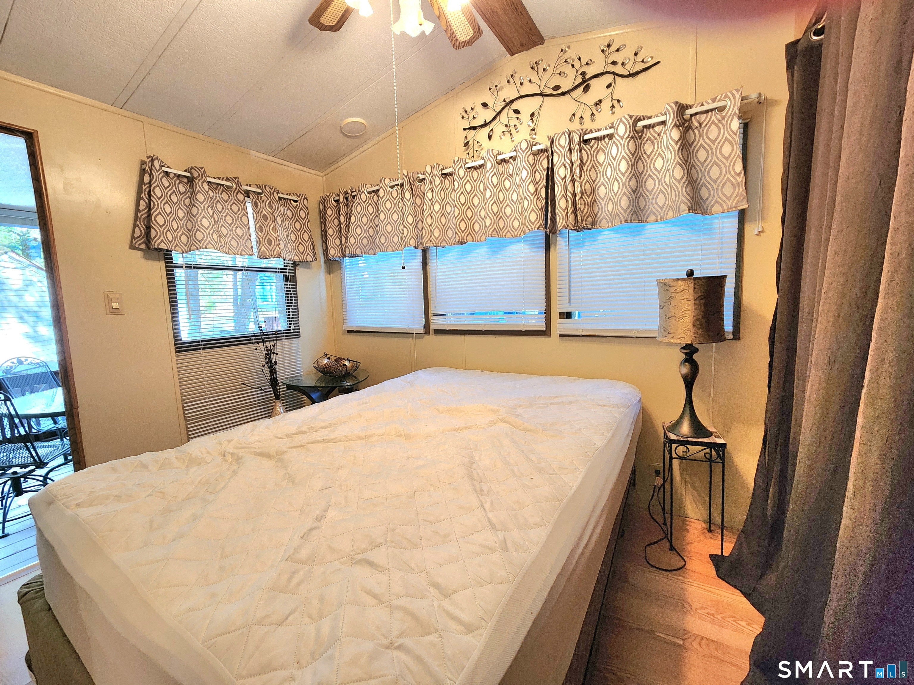 51 Old Springfield Road, Unit 123 Stafford, CT 06076 - Photo 5 of 19 a bed sitting in a bedroom next to a window