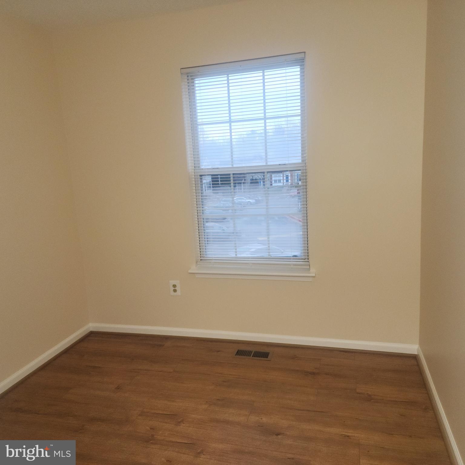 7438 Catterick Court Baltimore, MD 21244 - Photo 13 of 27 an empty room with wooden floor and windows