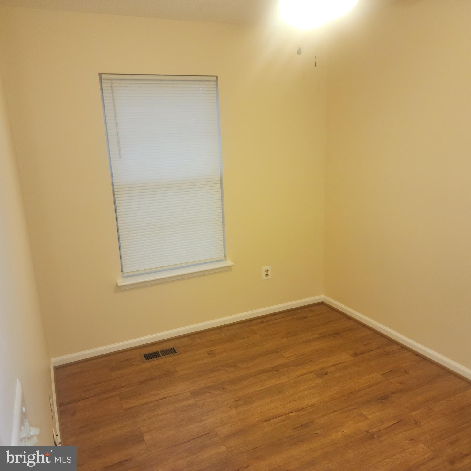 7438 Catterick Court Baltimore, MD 21244 - Photo 14 of 27 an empty room with a wooden door and a window
