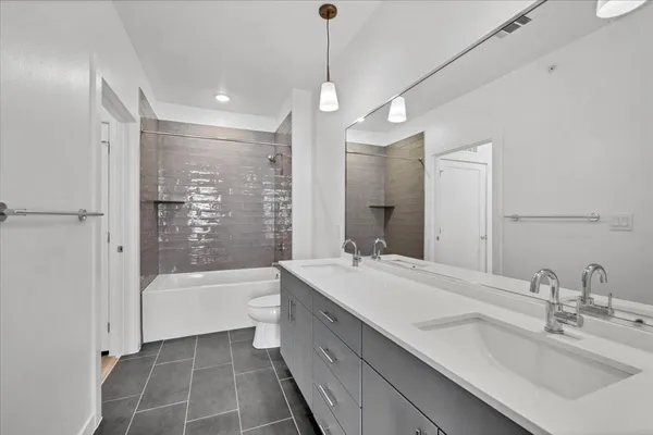 a bathroom with a tub sink shower and a mirror