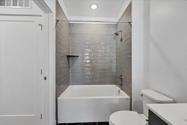 a bathroom with a toilet and a bathtub